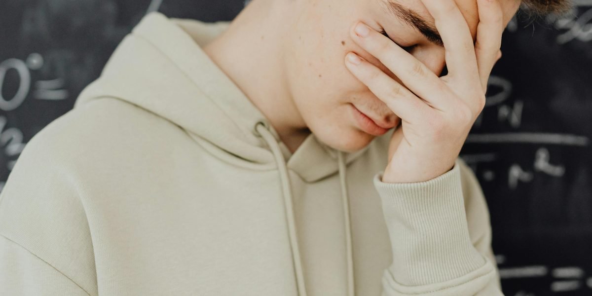 A person looking thoughtful, symbolizing the confusion that can arise from ambiguous naming in code.