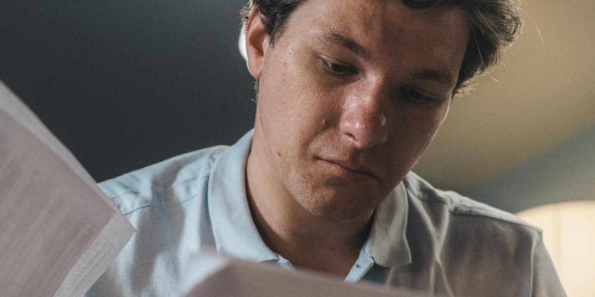 A person intently reviewing documents or code, embodying the focus required to avoid subtle programming errors.