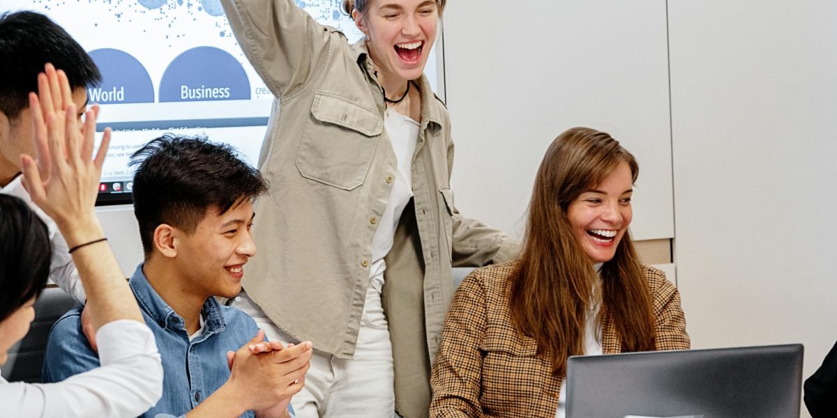 A diverse team of professionals celebrating a successful project completion or achievement.
