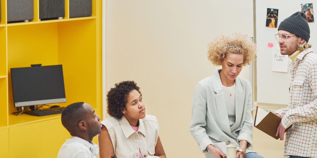 A team engages in a lively discussion, fostering an environment of peer learning and constructive feedback.