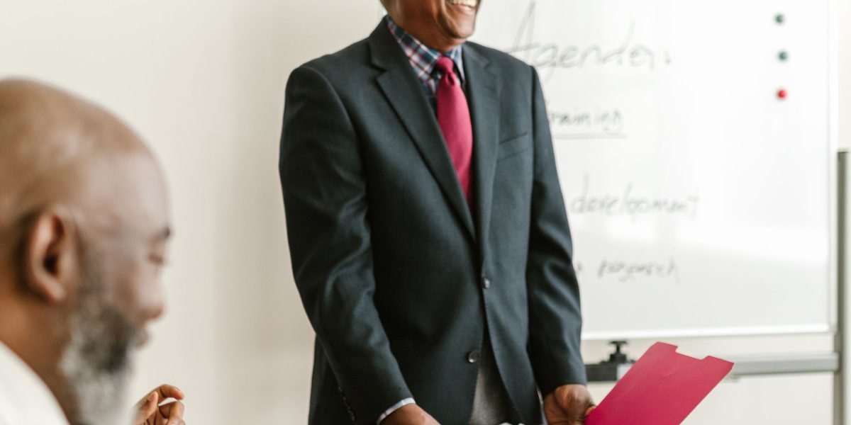 A person confidently presenting their work or project, highlighting real-world skills and achievements in a professional setting.