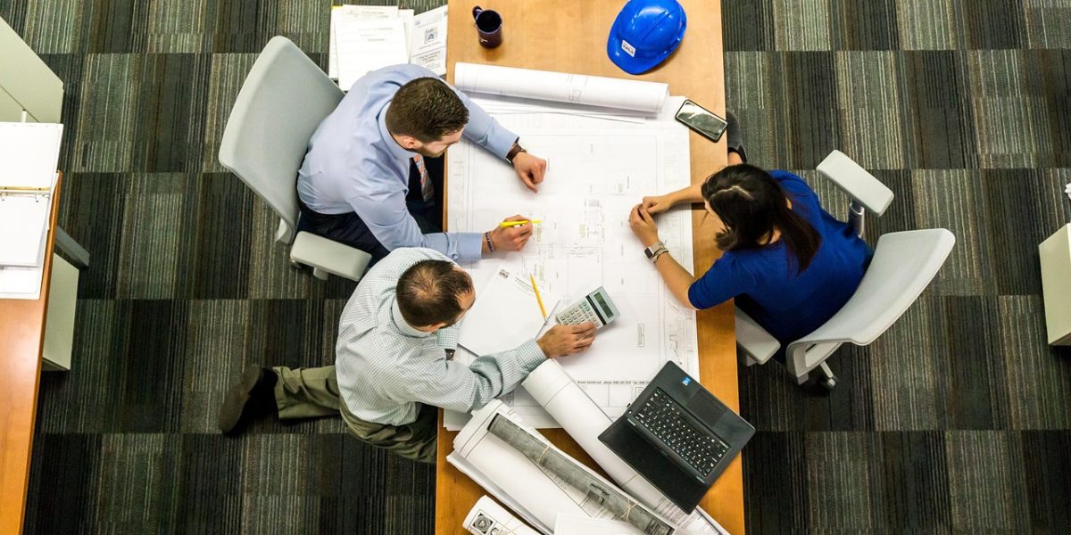 A diverse group of professionals in a meeting, intently discussing complex issues, symbolizing the technical hurdles in open AI.