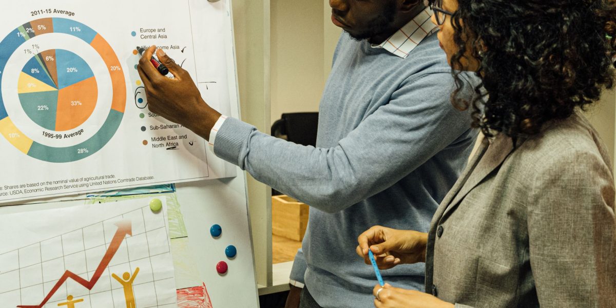 Professionals in a meeting discussing strategic plans for monetization, retention, and growth for a product.