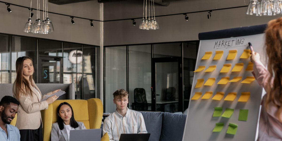 A diverse team collaboratively brainstorming ideas on a whiteboard, embodying continuous innovation driven by AI.