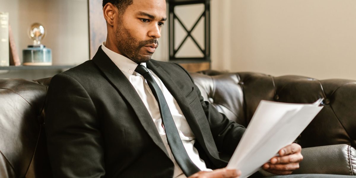 A professional meticulously examining reports, symbolizing the careful decision-making process for project leaders.