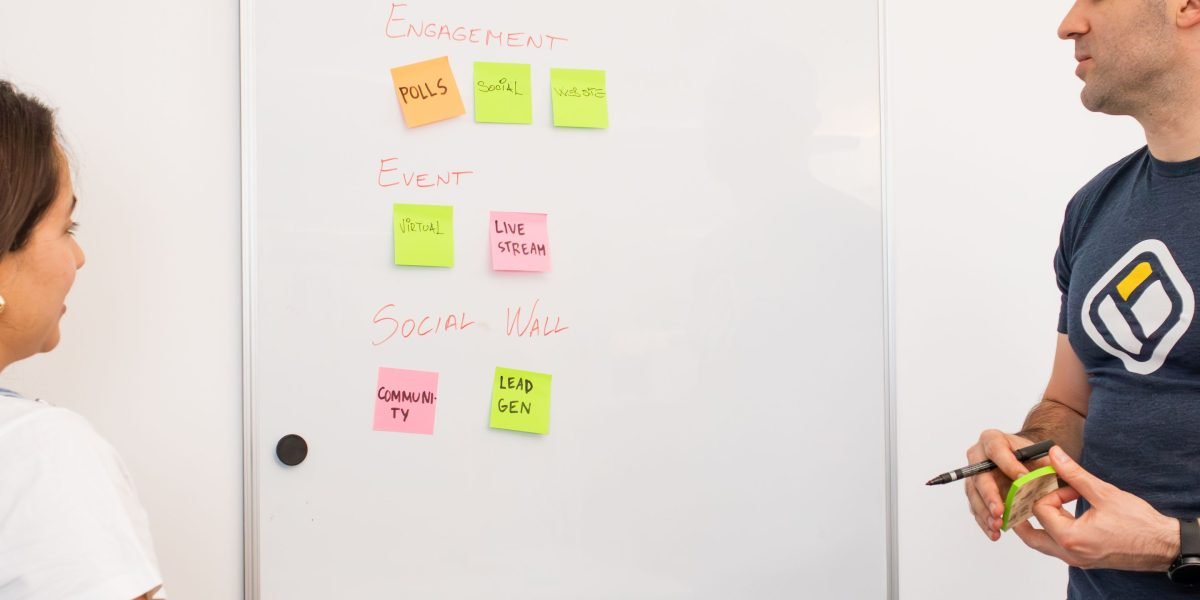 A team actively discussing various project management methodologies, symbolizing the selection of an SDLC model.