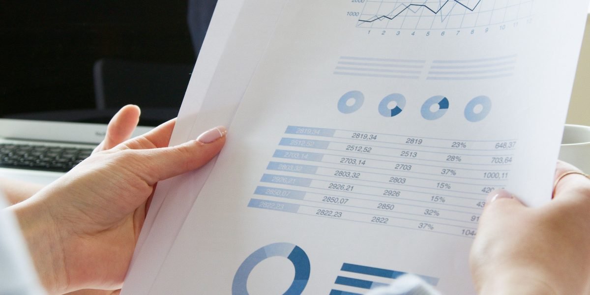 A professional reviewing performance reports, symbolizing the evaluation and testing of AI system effectiveness.