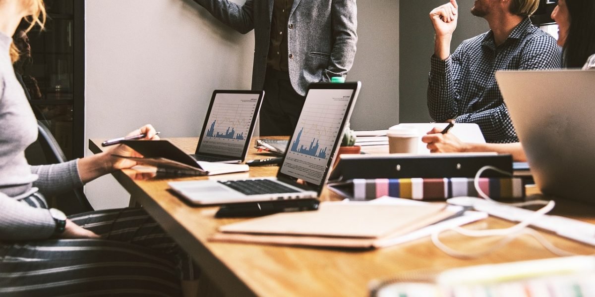 A diverse group of professionals collaborating in an open office, emphasizing teamwork and shared expertise for AI success.
