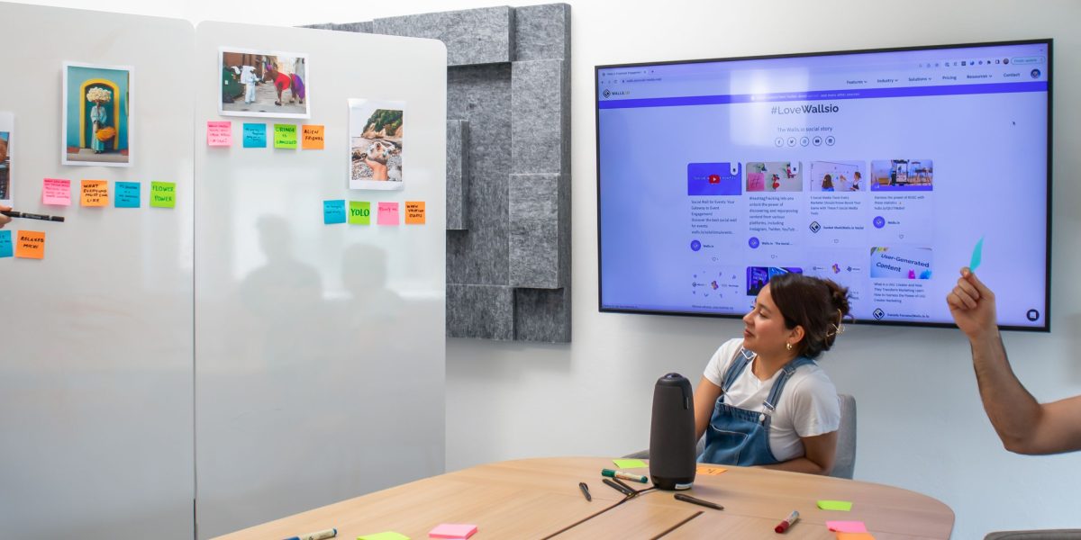 A team collaborating around a whiteboard, discussing app performance metrics and goals.