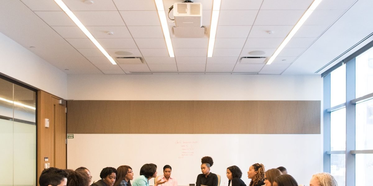 A diverse group in a meeting setting, engaging in a serious discussion about ethical guidelines and policies.