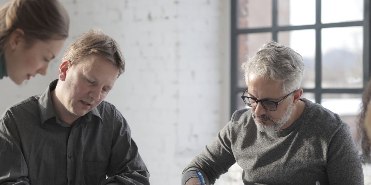 Professionals coordinate tasks seamlessly, reflecting the efficient producer-consumer pattern in software systems.