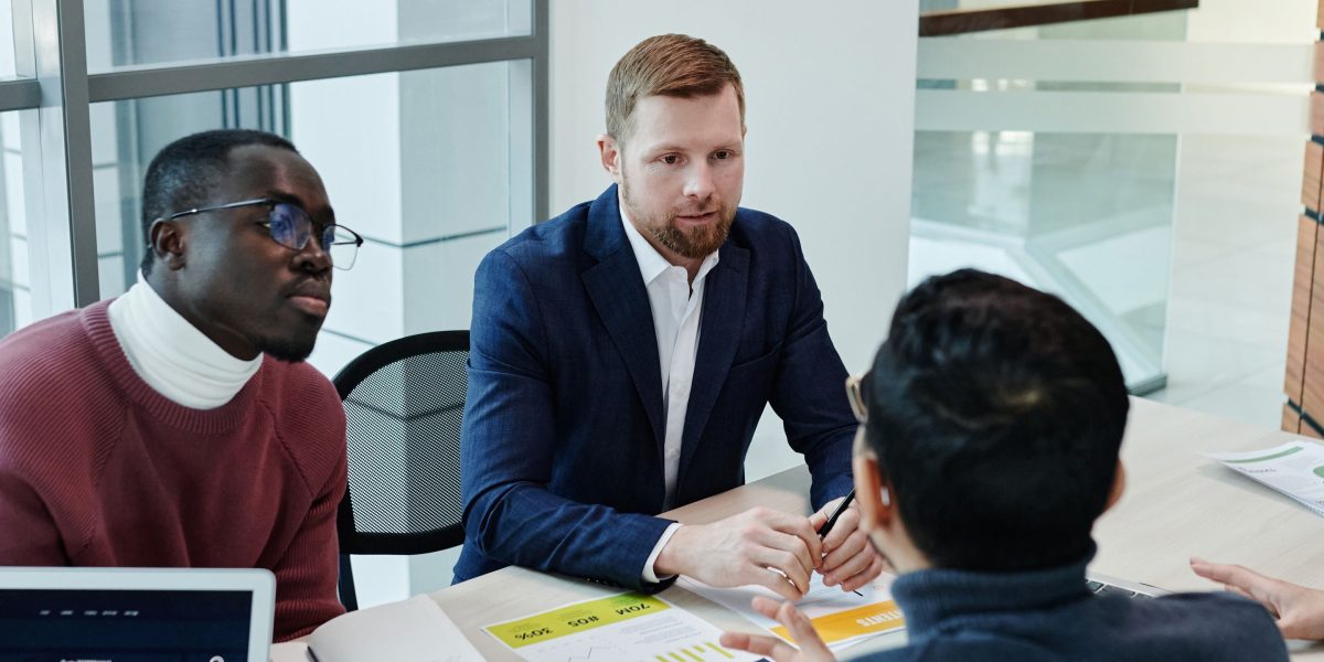 A team of professionals engaged in strategic discussion, planning how AI can enhance their product development efforts.