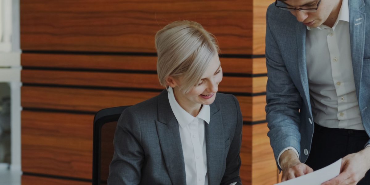 An experienced mentor providing guidance to a younger professional, emphasizing the importance of learning new skills and mentorship in engineering.