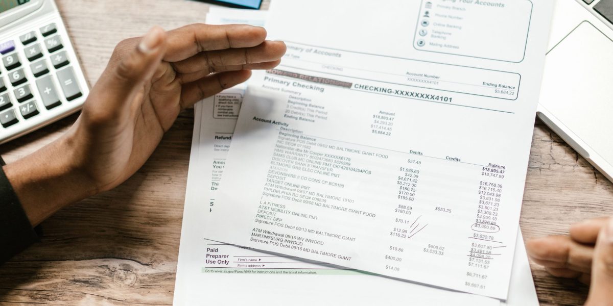A focused individual reviews financial documents, carefully managing project budgets.