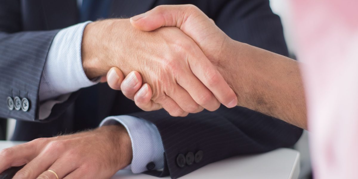 Two professionals finalize an agreement, symbolizing the start of a productive partnership.