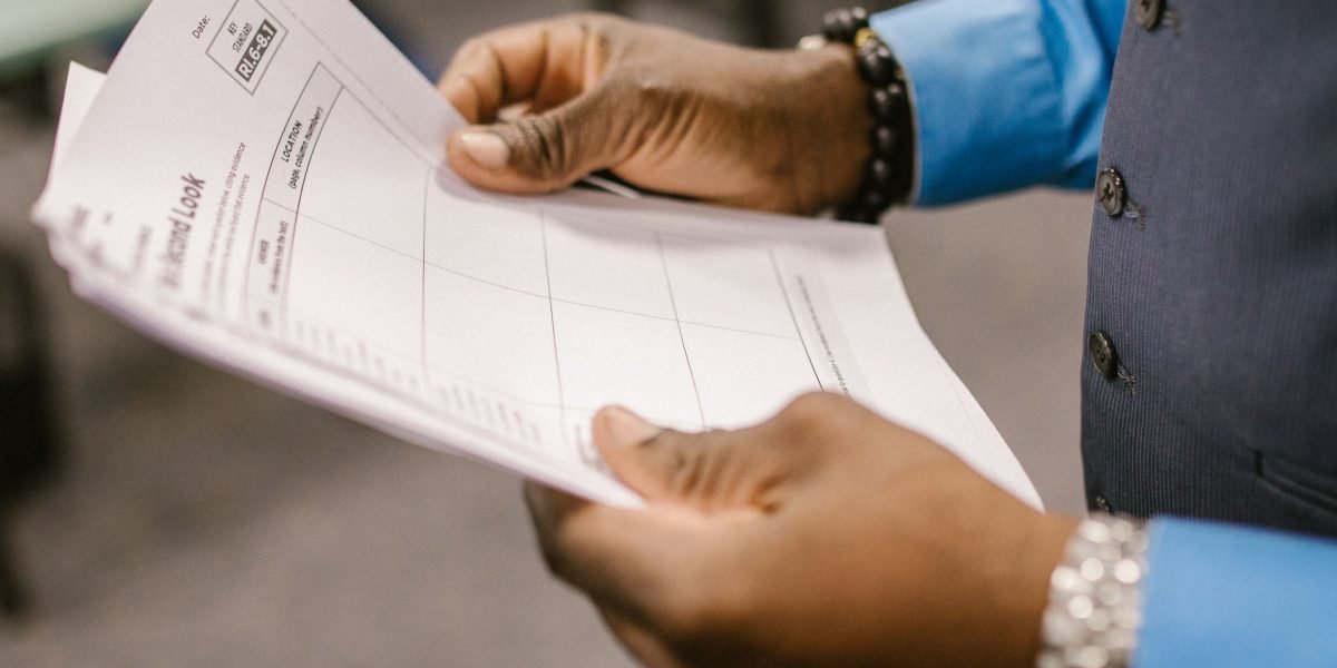 An individual carefully considering different options and factors before making a strategic decision.